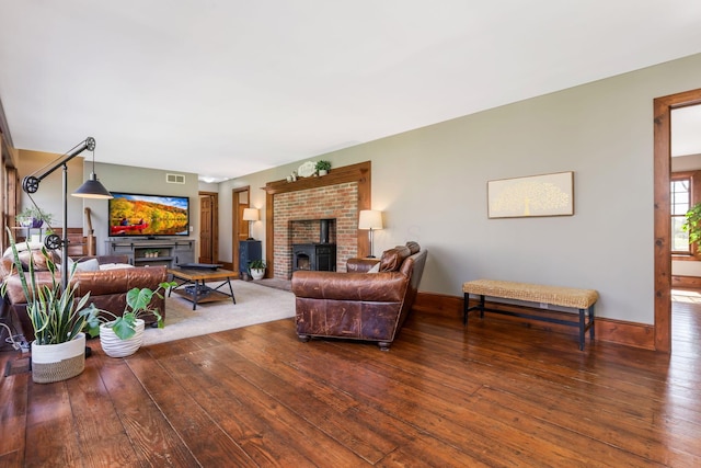 living room featuring wood-type flooring, baseboards, and visible vents