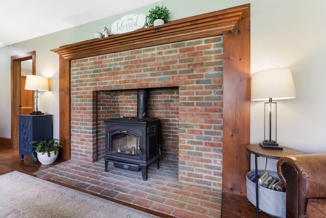 room details with wood finished floors and a wood stove