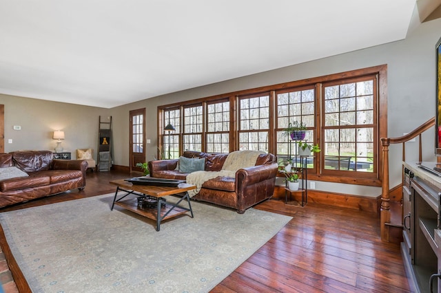 living room with dark wood-type flooring and baseboards