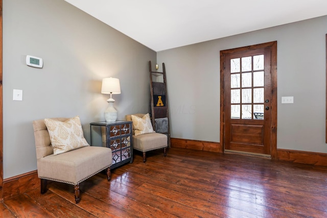sitting room featuring vaulted ceiling, baseboards, and wood-type flooring