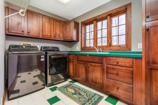 laundry room featuring washing machine and clothes dryer, a sink, and cabinet space