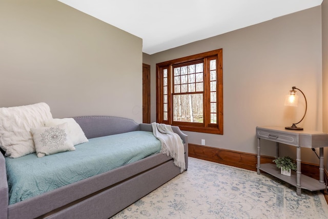 bedroom with baseboards and wood finished floors