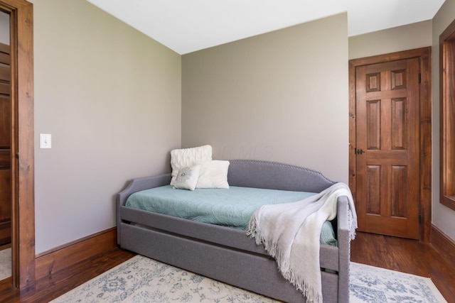 bedroom featuring baseboards and wood finished floors