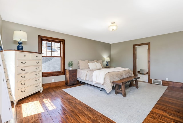 bedroom with baseboards, visible vents, and dark wood-style floors