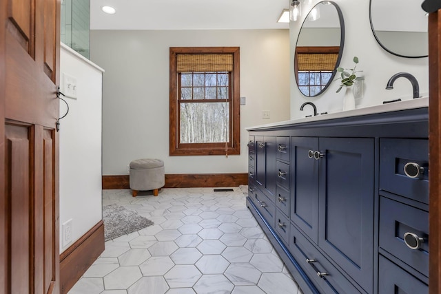 bathroom featuring tile patterned floors, baseboards, and vanity