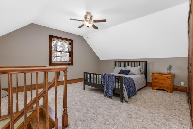 bedroom featuring lofted ceiling, baseboards, and carpet flooring