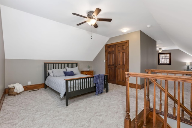 bedroom featuring vaulted ceiling, carpet floors, baseboards, and visible vents