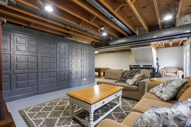 living area featuring pool table and concrete flooring