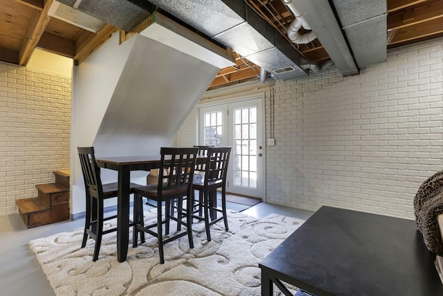 dining room with brick wall and stairway