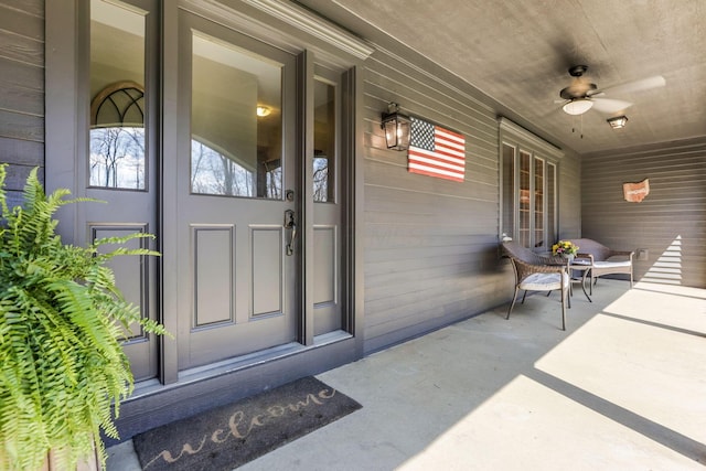 doorway to property with a ceiling fan and covered porch