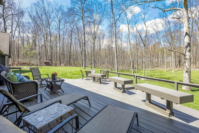 wooden terrace with a lawn and outdoor dining area