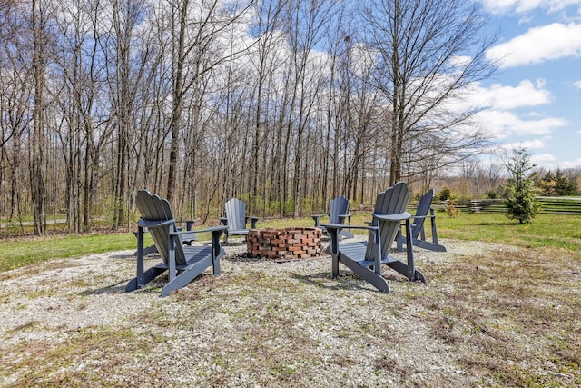 view of yard with fence and an outdoor fire pit