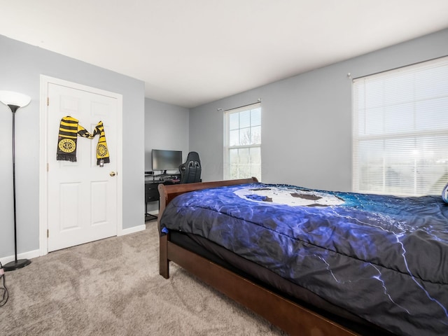 carpeted bedroom with baseboards