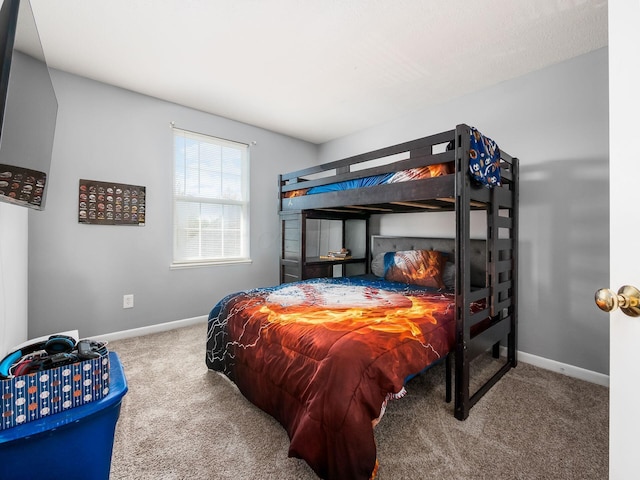 bedroom featuring carpet floors and baseboards