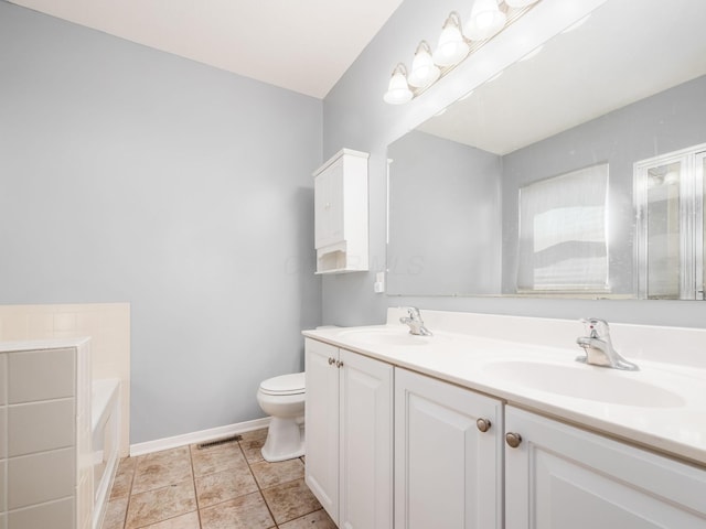 full bathroom with a sink, toilet, double vanity, and visible vents