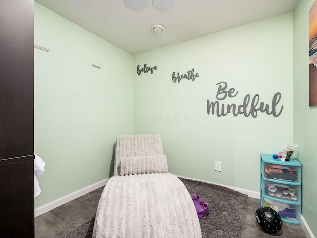 sitting room featuring baseboards and tile patterned flooring