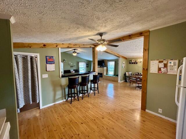 9330 Pidcock Rd, Zanesville, OH 43701 - interior space featuring light wood finished floors, freestanding refrigerator, a textured ceiling, and ceiling fan