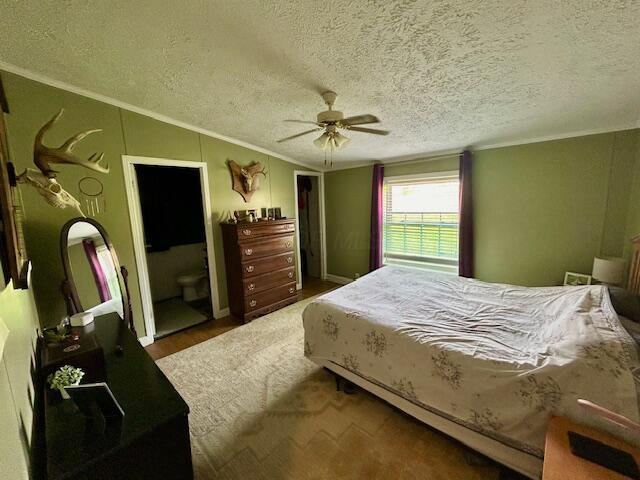 9330 Pidcock Rd, Zanesville, OH 43701 - bedroom featuring vaulted ceiling, a textured ceiling, ceiling fan, and crown molding