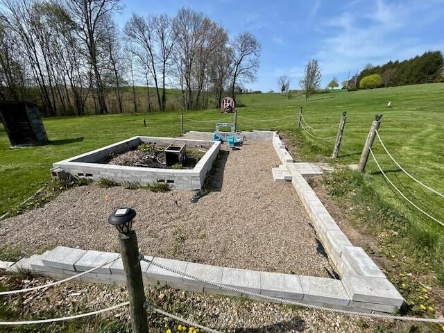 9330 Pidcock Rd, Zanesville, OH 43701 - entry to storm shelter featuring a rural view and a yard
