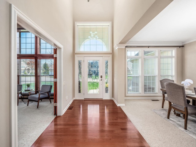 7766 Dickens Ct, Delaware, OH 43015 - entryway featuring baseboards, crown molding, wood finished floors, and plenty of natural light
