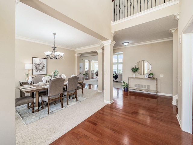 7766 Dickens Ct, Delaware, OH 43015 - dining space with baseboards, decorative columns, wood finished floors, and crown molding
