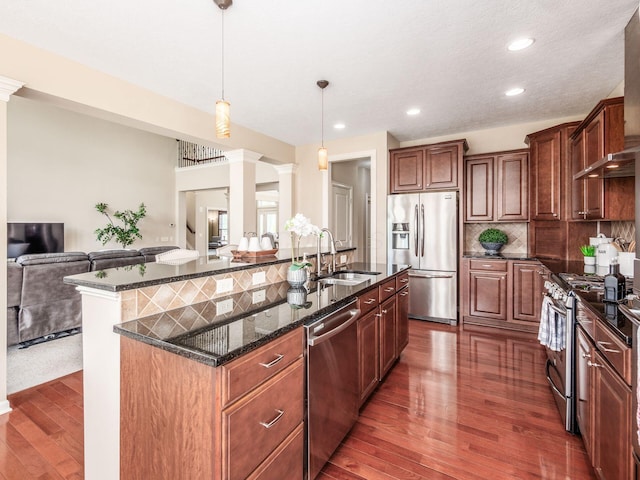 7766 Dickens Ct, Delaware, OH 43015 - kitchen featuring dark wood-style floors, appliances with stainless steel finishes, ornate columns, and a sink