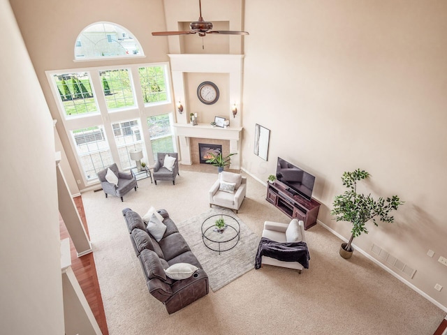 7766 Dickens Ct, Delaware, OH 43015 - living area with plenty of natural light, carpet floors, a towering ceiling, and a tiled fireplace