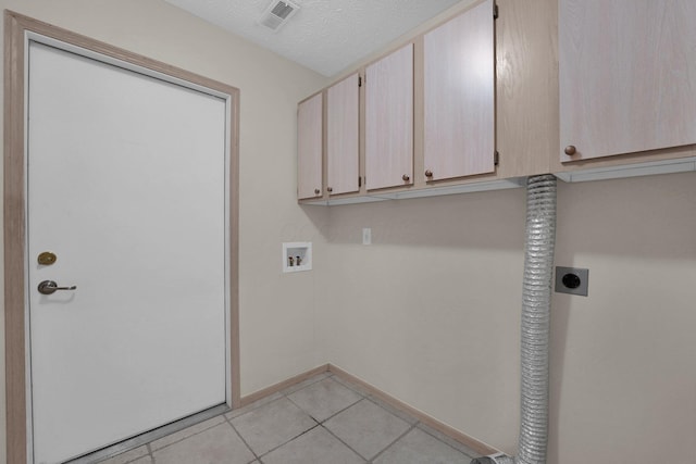 5585 Meadowood Ln, Westerville, OH 43082 - laundry area with cabinet space, hookup for an electric dryer, visible vents, light tile patterned floors, and hookup for a washing machine