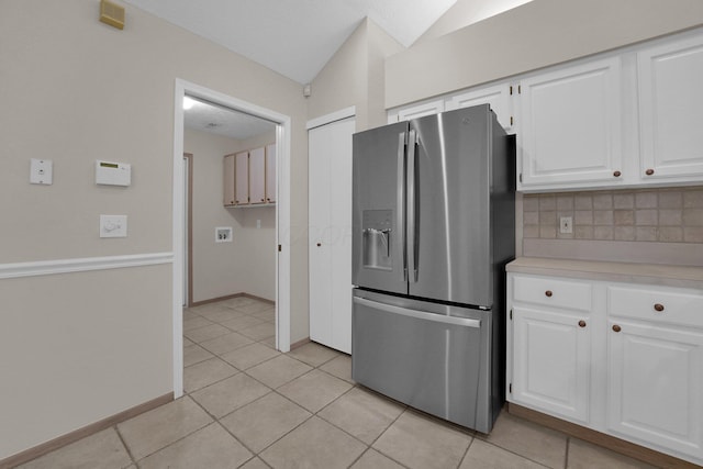 5585 Meadowood Ln, Westerville, OH 43082 - kitchen featuring light countertops, white cabinetry, light tile patterned flooring, and stainless steel refrigerator with ice dispenser