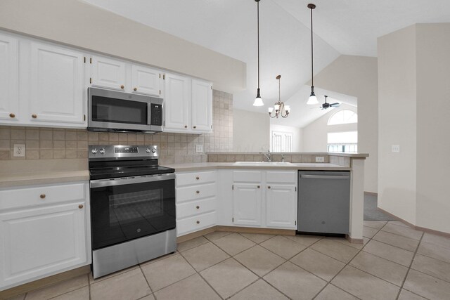 5585 Meadowood Ln, Westerville, OH 43082 - kitchen featuring a peninsula, decorative backsplash, light countertops, appliances with stainless steel finishes, and vaulted ceiling