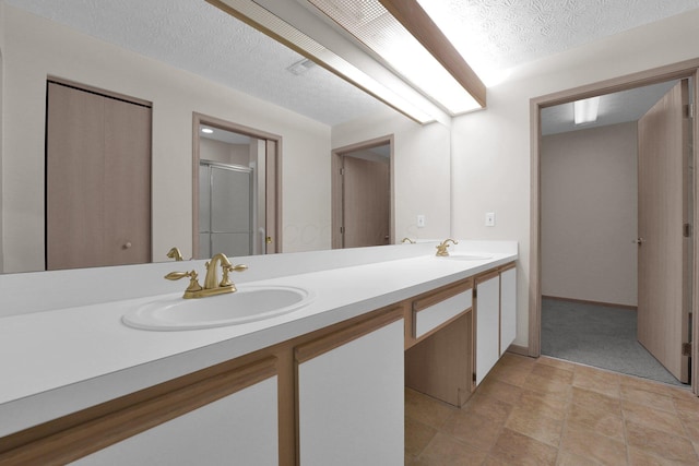 5585 Meadowood Ln, Westerville, OH 43082 - full bathroom with a shower stall, a textured ceiling, double vanity, and a sink