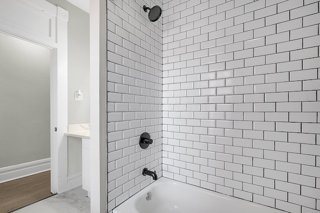 full bath with marble finish floor, baseboards, and shower / washtub combination