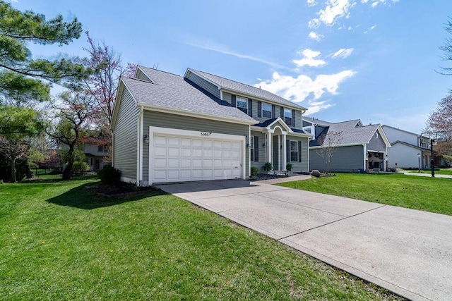 view of front facade featuring driveway, a front lawn, and a garage