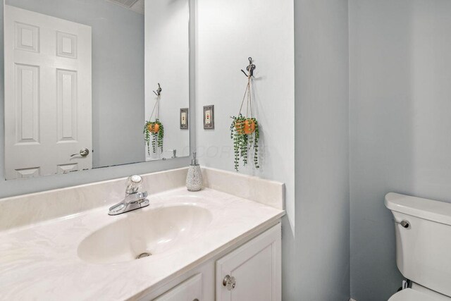 bathroom featuring toilet and vanity