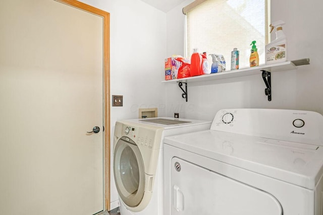 clothes washing area with washing machine and clothes dryer and laundry area