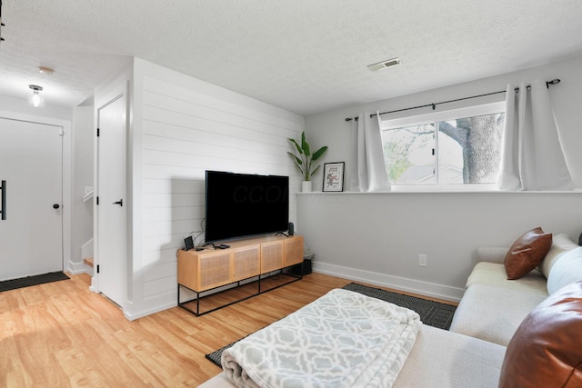 5133 Hidden View Dr, Hilliard, OH 43026 - living room featuring wood finished floors, a textured ceiling, and baseboards