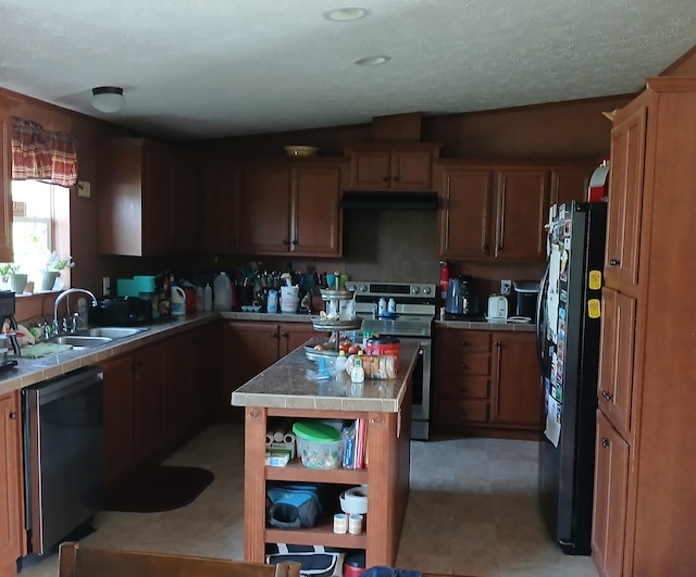 kitchen featuring tile counters, stainless steel appliances, extractor fan, a sink, and a center island
