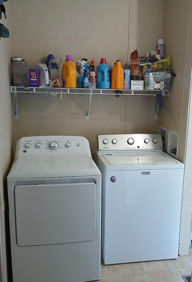 laundry area featuring light tile patterned flooring, laundry area, and separate washer and dryer