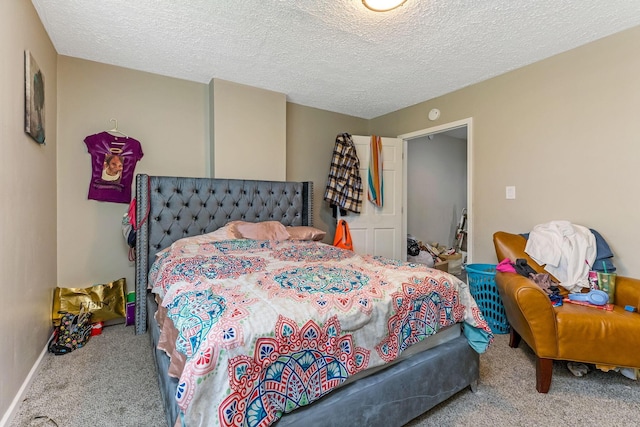 bedroom featuring a textured ceiling, carpet flooring, and baseboards