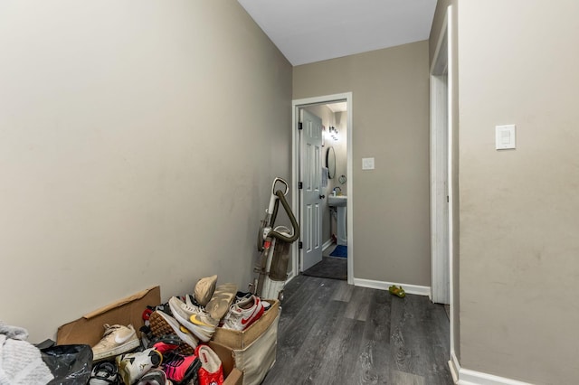 hall with baseboards and dark wood finished floors