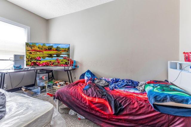 bedroom with carpet floors and a textured ceiling