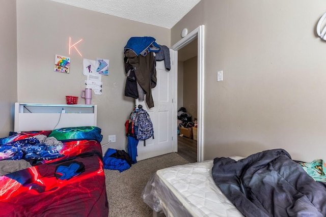 bedroom with a textured ceiling and carpet