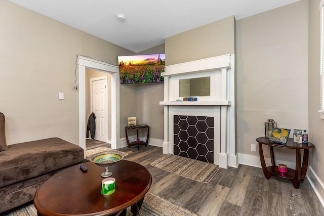living area with baseboards and wood finished floors