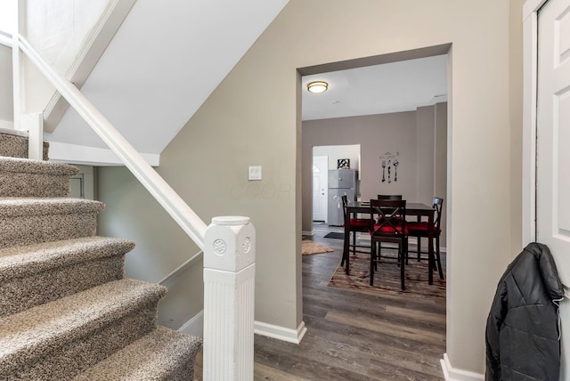 stairs featuring baseboards and wood finished floors