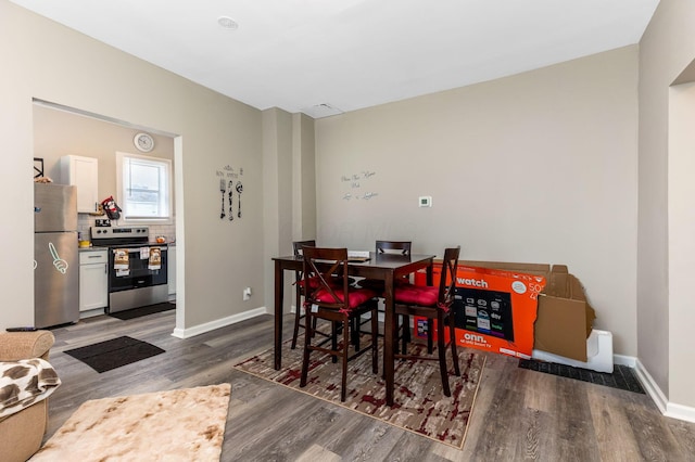 dining room featuring wood finished floors and baseboards