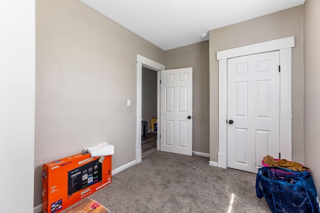 carpeted bedroom featuring baseboards