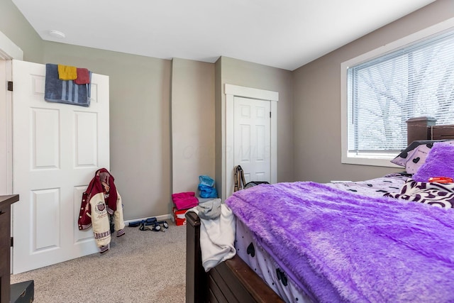 carpeted bedroom featuring baseboards