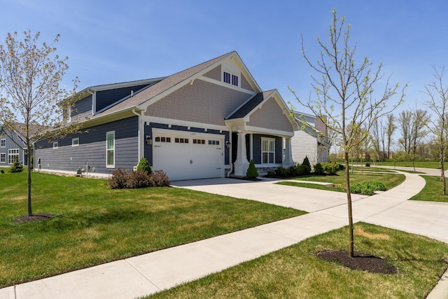 craftsman house featuring a garage, driveway, and a front yard
