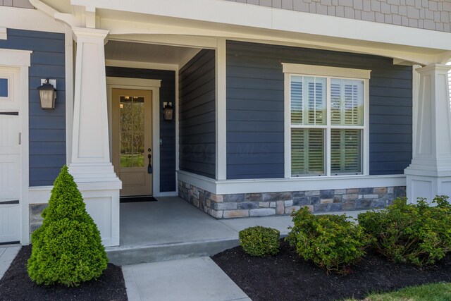 entrance to property featuring a porch