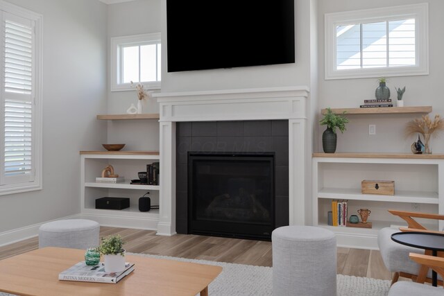 living area with wood finished floors and a fireplace